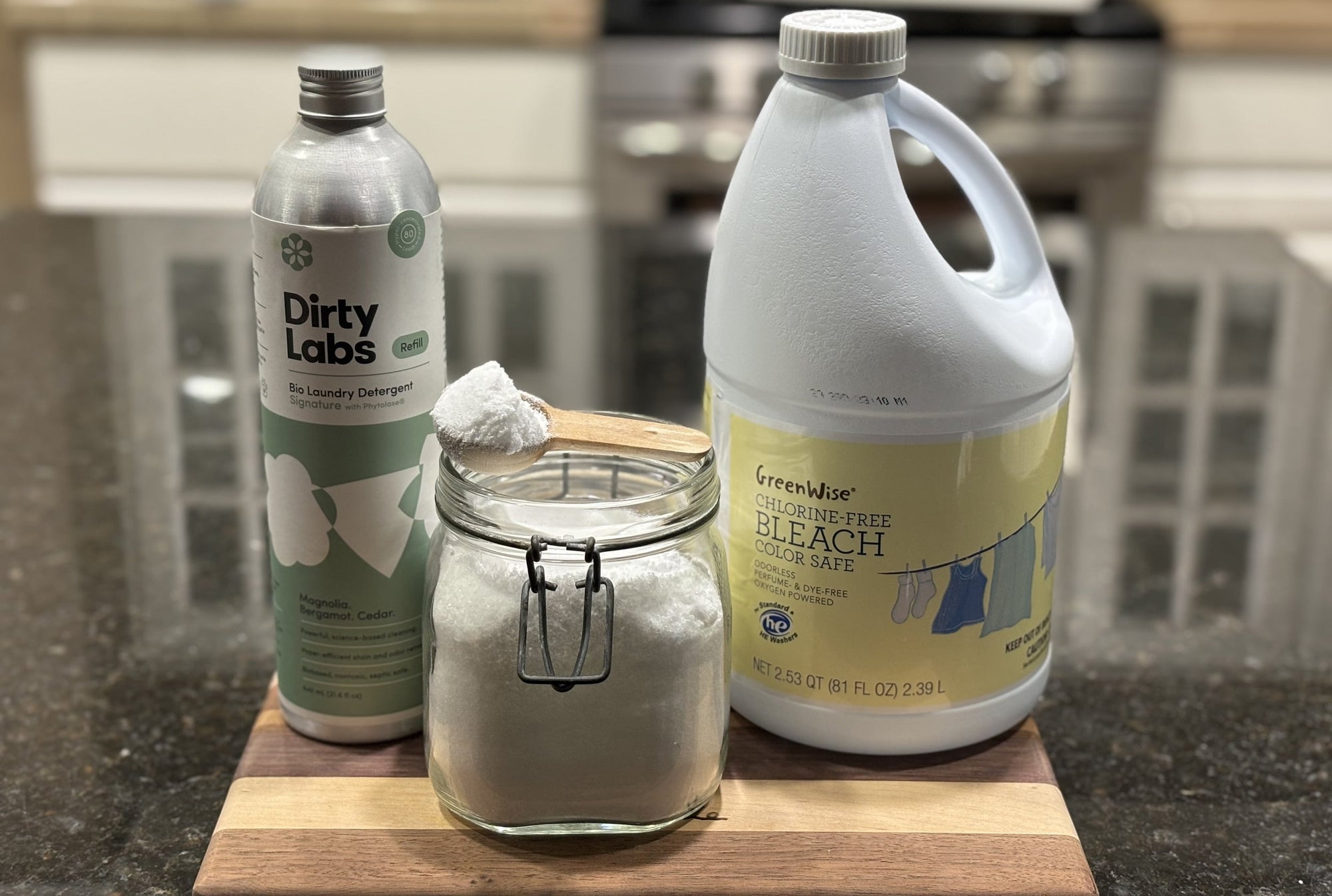 Nontoxic cleaning supplies sit on a sustainable wood board.