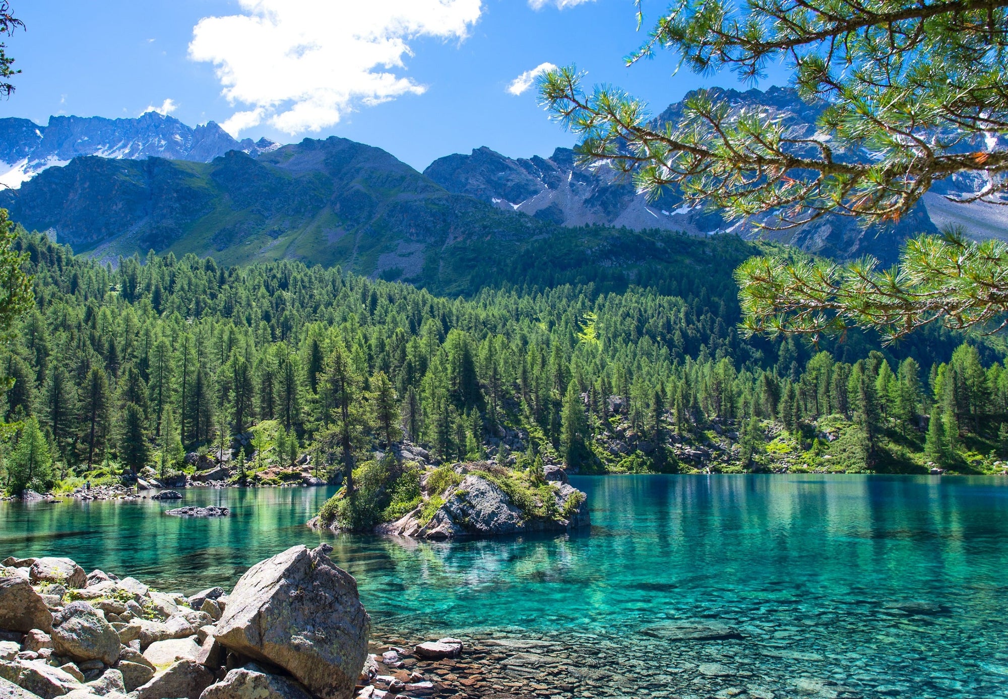 A stunningly clear aqua lake in the Swiss Alps, showing the beauty of nature when untouched by man.