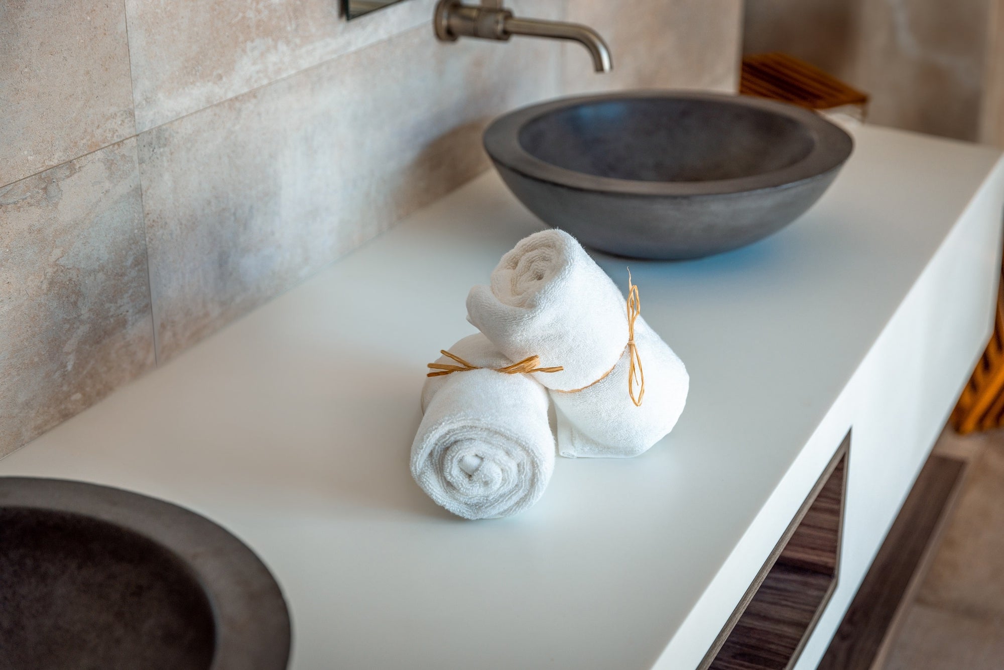 Organic towels rest on a modern sustainable bathroom countertop.